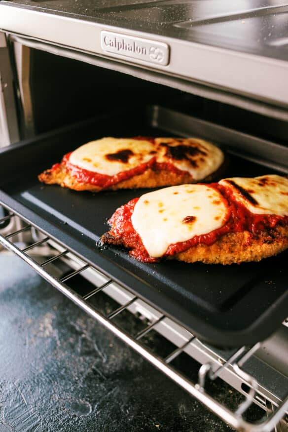 Air Fryer Chicken Parmesan coated with an Italian seasoned parmesan cheese breading. Air fried, then broiled with marinara and mozzarella.