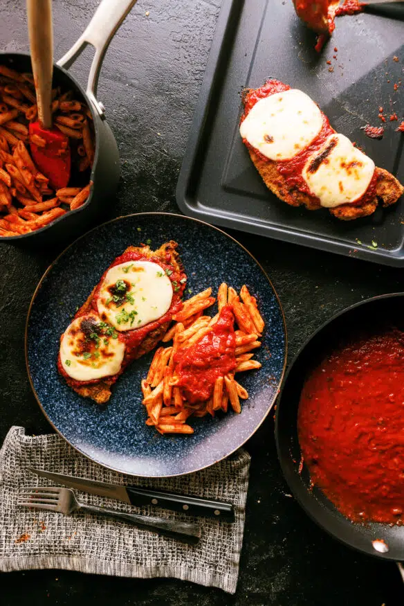 Air Fryer Chicken Parmesan coated with an Italian seasoned parmesan cheese breading. Air fried, then broiled with marinara and mozzarella.