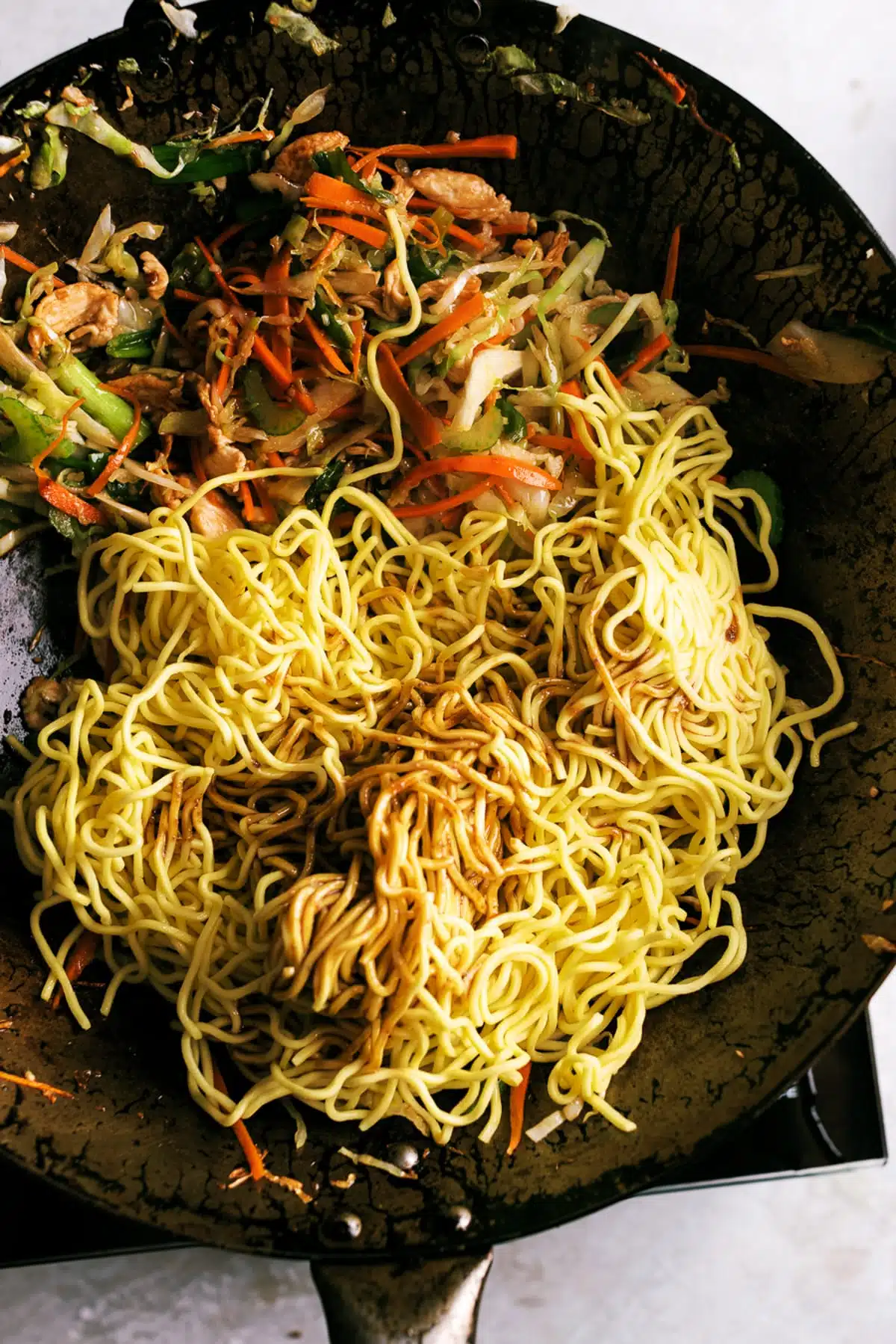 Chicken chow mein with a savory oyster and soy sauce. Includes step-by-step instructions with picture on how to cook chow mein in a wok