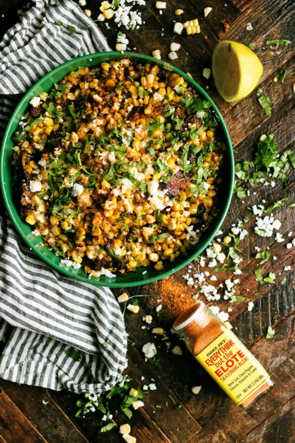 Hatch Chile and Bacon Esquites cooked on a blackstone flattop grill, loaded with cheese and absolutely delicious. Perfect as a game day snack, a topping for tacos, or just an amazing side dish to serve for dinner! 