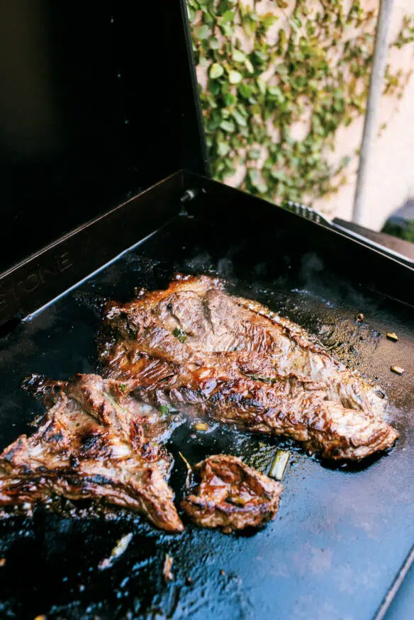 A Citrus and Beer based carne asada fries recipe right in time for game day season. Marinated flap meat grilled and chopped, and topped over cheese fries with all the fixings!