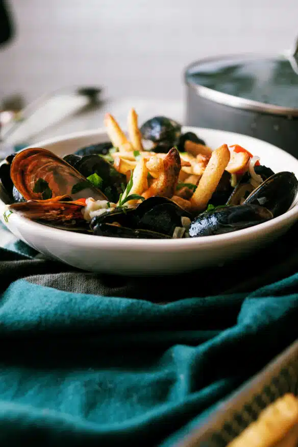 Mussels in a white wine cream sauce served over paprika fries is an easy to make recipe with little prep time!