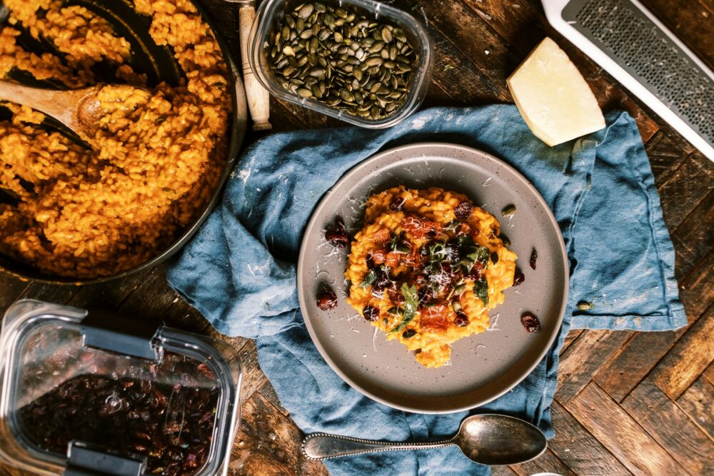 This Creamy Pumpkin Risotto is a fall must! loaded with bacon, parmesan and topped with crispy sage, pumpkin seeds and dried cranberries